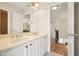 Bathroom showing dual sinks, large mirrors, and modern fixtures at 5470 Beaver Ridge Dr, Cumming, GA 30040