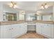 Bathroom featuring a double vanity with granite countertops and large mirrors at 5470 Beaver Ridge Dr, Cumming, GA 30040