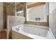 A modern tub sits beneath a window in this well-appointed bathroom at 5470 Beaver Ridge Dr, Cumming, GA 30040