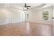 Spacious bedroom featuring hardwood floors, tray ceiling, and bright windows at 5470 Beaver Ridge Dr, Cumming, GA 30040