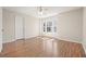 Bright bedroom features hardwood floors, neutral walls, and a ceiling fan at 5470 Beaver Ridge Dr, Cumming, GA 30040