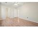 Neutral bedroom with hardwood floors, ceiling fan, and access to closet and bathroom at 5470 Beaver Ridge Dr, Cumming, GA 30040