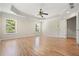 Spacious bedroom featuring hardwood flooring, tray ceiling and bright windows at 5470 Beaver Ridge Dr, Cumming, GA 30040