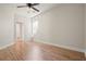 Neutral bedroom with hardwood floors, ceiling fan, and a window for natural light at 5470 Beaver Ridge Dr, Cumming, GA 30040