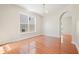 Bright dining room featuring hardwood floors, a chandelier, and an arched entryway at 5470 Beaver Ridge Dr, Cumming, GA 30040