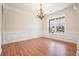 Dining room featuring hardwood floors, wainscoting, chandelier, and large window view at 5470 Beaver Ridge Dr, Cumming, GA 30040