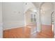 Open-concept dining room with hardwood floors, arched doorways, and custom wainscoting at 5470 Beaver Ridge Dr, Cumming, GA 30040