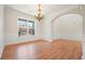 Elegant dining room with hardwood floors, wainscoting, chandelier, and large window at 5470 Beaver Ridge Dr, Cumming, GA 30040