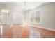 Bright dining room with hardwood floors, arched doorways, wainscoting, and large window at 5470 Beaver Ridge Dr, Cumming, GA 30040