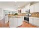 Bright kitchen with white cabinets, stainless steel appliances, granite counters, and center island at 5470 Beaver Ridge Dr, Cumming, GA 30040