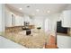 Bright kitchen with white cabinets, stainless steel appliances, granite counters, and center island at 5470 Beaver Ridge Dr, Cumming, GA 30040