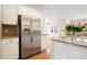 Bright kitchen with white cabinets, stainless steel appliances, granite counters, and center island at 5470 Beaver Ridge Dr, Cumming, GA 30040