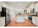 Bright kitchen with white cabinets, stainless steel appliances, granite counters, and center island at 5470 Beaver Ridge Dr, Cumming, GA 30040
