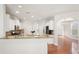 Bright kitchen with white cabinets, stainless steel appliances, granite counters, and center island at 5470 Beaver Ridge Dr, Cumming, GA 30040
