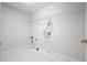 An empty laundry room with white tiled floors and a chrome rack at 5470 Beaver Ridge Dr, Cumming, GA 30040