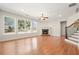 Bright living room with hardwood floors, fireplace, and large windows showcasing the outdoors at 5470 Beaver Ridge Dr, Cumming, GA 30040