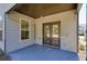 Covered patio features double doors and a view of the fenced backyard at 5470 Beaver Ridge Dr, Cumming, GA 30040