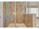 The stand-up shower is tiled and enclosed with seamless glass at 5470 Beaver Ridge Dr, Cumming, GA 30040