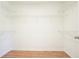 Empty walk-in closet featuring hardwood floors and shelving at 5470 Beaver Ridge Dr, Cumming, GA 30040