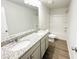 Bathroom featuring a double sink vanity, granite countertop, and tub with shower at 5518 Legacy Trl, Douglasville, GA 30135