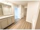 Modern bathroom featuring double vanity with granite countertops, soaking tub, and walk-in closet at 5518 Legacy Trl, Douglasville, GA 30135