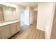 Modern bathroom featuring double vanity with granite countertops, soaking tub, and walk-in closet at 5518 Legacy Trl, Douglasville, GA 30135