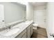 Bathroom featuring a double sink vanity, granite countertop, and tub with shower at 5518 Legacy Trl, Douglasville, GA 30135