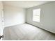 Bright, carpeted bedroom with neutral walls, a window, and an electrical outlet ready for personalization at 5518 Legacy Trl, Douglasville, GA 30135
