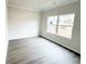 Bright, carpetless bedroom with ample natural light and a large window overlooking the neighborhood at 5518 Legacy Trl, Douglasville, GA 30135