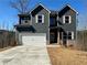 Charming two-story home featuring a two-car garage and classic architectural details, lovely landscaping at 5518 Legacy Trl, Douglasville, GA 30135