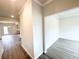 Open hallway with wood-look flooring with an entryway to a bedroom or office at 5518 Legacy Trl, Douglasville, GA 30135