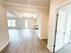 Spacious living room with wood-look floors flowing to the backyard, kitchen, and bedrooms at 5518 Legacy Trl, Douglasville, GA 30135