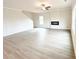 Spacious open-concept living room featuring a modern fireplace with lots of natural light at 5518 Legacy Trl, Douglasville, GA 30135