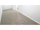 Neutral carpet in a walk-in closet featuring simple painted white walls, and a doorway to another room at 5518 Legacy Trl, Douglasville, GA 30135