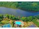 Aerial view of a neighborhood pool near a beautiful lake at 901 Blue Sky Rdg, Snellville, GA 30078