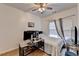 Well-lit bedroom with ceiling fan, window, work desk and luxury vinyl flooring at 901 Blue Sky Rdg, Snellville, GA 30078