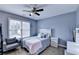 Cozy bedroom with a large window, stylish furniture, and calming blue walls at 901 Blue Sky Rdg, Snellville, GA 30078