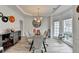 Dining room with a modern glass table, stylish chairs, modern decor and lots of natural light at 901 Blue Sky Rdg, Snellville, GA 30078