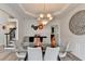 Sophisticated dining room featuring a glass table, stylish chandelier, and modern decor at 901 Blue Sky Rdg, Snellville, GA 30078