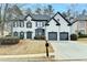 Two-story house with a two-car garage, painted white with black trim and windows on a winter lawn at 901 Blue Sky Rdg, Snellville, GA 30078