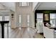 Spacious open floor plan featuring a large foyer, dining room, and seating area, all with light wood flooring at 901 Blue Sky Rdg, Snellville, GA 30078