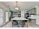 Beautiful kitchen with green cabinets, a large center island, and modern appliances at 901 Blue Sky Rdg, Snellville, GA 30078