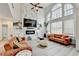 Bright living room with fireplace, TV and two-story windows at 901 Blue Sky Rdg, Snellville, GA 30078