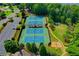 Aerial view of community tennis courts, parking, and a playground at 901 Blue Sky Rdg, Snellville, GA 30078