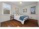 Charming bedroom with hardwood floors, two windows, and soft, neutral decor at 127 Oldenburg Dr, Riverdale, GA 30274
