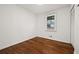 Empty bedroom showcasing hardwood floors, one window, and a closet with bi-fold doors at 127 Oldenburg Dr, Riverdale, GA 30274