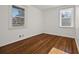 Bedroom with hardwood floors and two windows offering natural light at 127 Oldenburg Dr, Riverdale, GA 30274