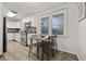 Modern kitchen features updated appliances, stylish backsplash, and eat-in kitchen at 127 Oldenburg Dr, Riverdale, GA 30274