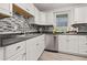 Well-equipped kitchen featuring modern appliances, stylish backsplash, and ample counter space at 127 Oldenburg Dr, Riverdale, GA 30274