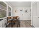 Bright kitchen featuring a dining table with chairs, large window, and wood flooring at 127 Oldenburg Dr, Riverdale, GA 30274